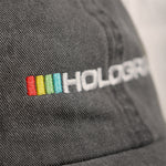 Macro view of the embroidery on the Hologram Electronics logo hat