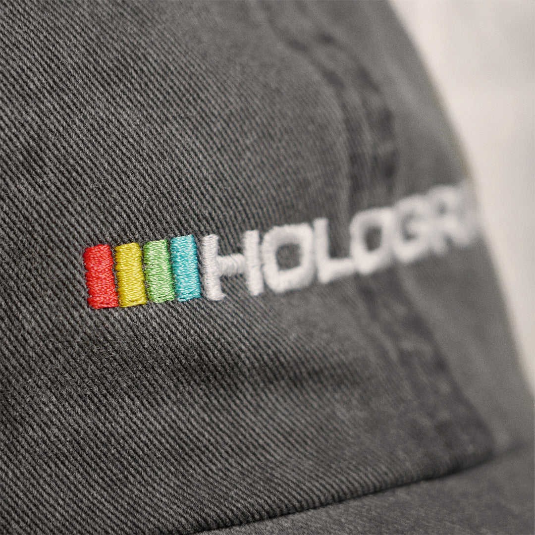 Macro view of the embroidery on the Hologram Electronics logo hat